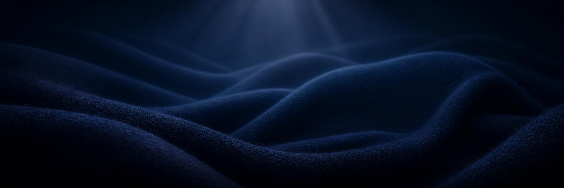Folds of ultrafine merino wool in deep ocean navy